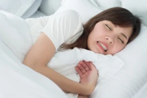 woman asleep with grinding disorder woman asleep with grinding disorder